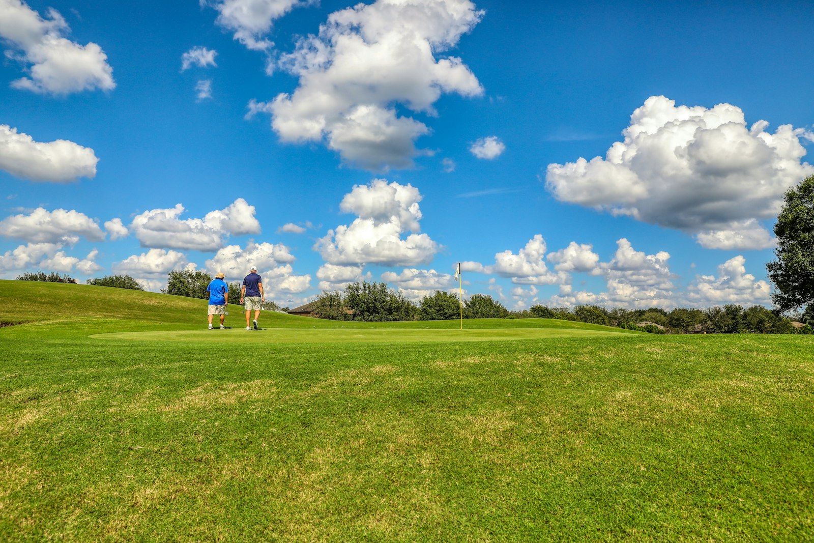 Golfers on a sunny Florida course with clear blue skies near Port St Lucie — perfect snowbird winter golf